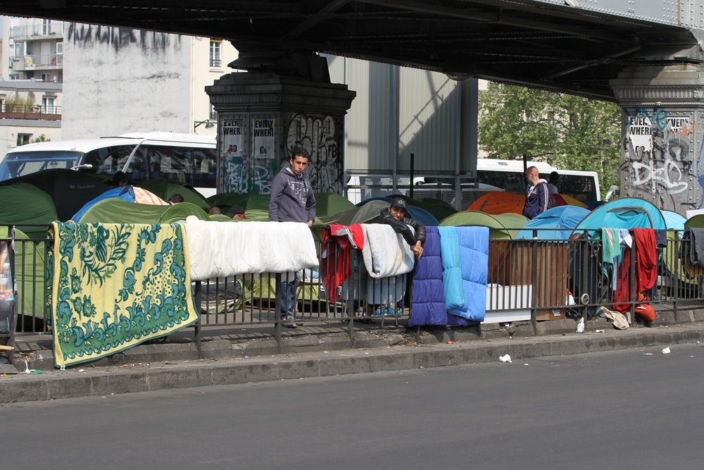 refugees living under a bridge in Paris France