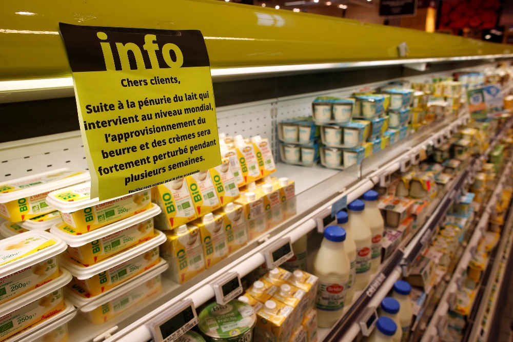 A placard explaining the butter shortage is displayed on milk products shelves at a supermarket in Saint-Sebastien-sur-Loire